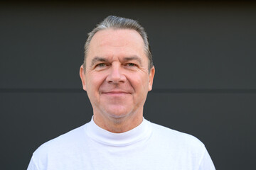 Fototapeta premium Man giving a calm smile with mouth closed without his dental prosthesis