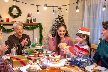 Happy people are celebrating on a table meal when christmas and new year at home.
