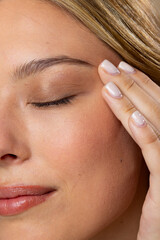 Close up of caucasian woman wearing natural makeup and beige nail polish