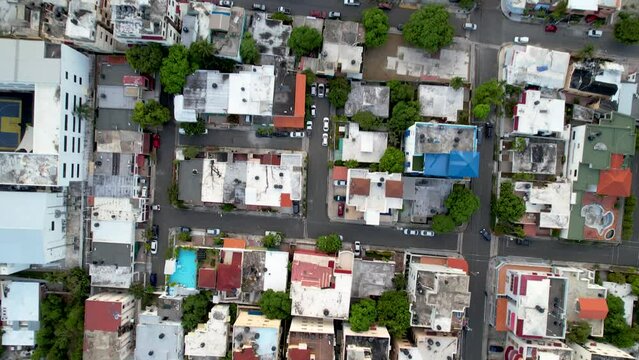 Aerial cinematic footage of the city of Santo Domingo, Capital Of Dominican Republic, its beautiful streets and buildings, la Fuente Centro de los Heroes, the Pabellón de las Naciones