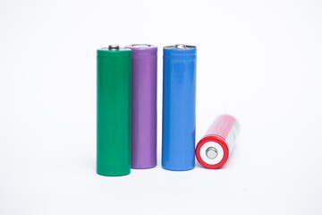 4 colorful cylindrical batteries on a white background. Storage battery or secondary cell. Rechargeable Li-ion batteries for electrical appliances and devices