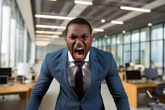 portrait of angry black businessman in office screaming at camera