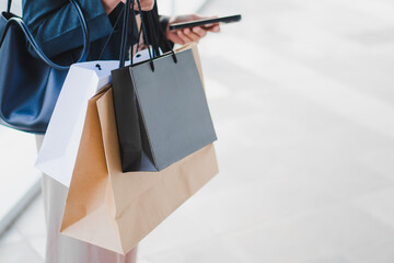 Close-up of lady is carrying shopping bags in her hand