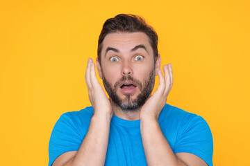 Studio portrait of a man shocked. Surprised man in blue t-shirt shouting wow, omg, isolated on...
