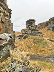 Two brothers rocks near Cape Zemlyanoi on the Kola Peninsula. Natural weathering pillars. The rocky coast of the Barents Sea. The ancient sanctuary of the Sami. Arctic Russia.