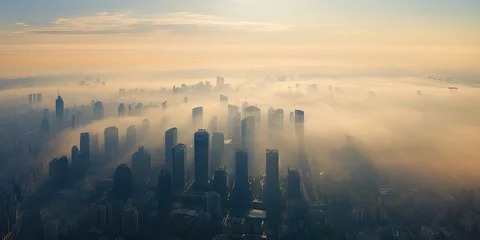 Poster City veiled in sunrise. Aerial view with river and fog. Skyline and river amidst morning mist. Urban awakening over river and haze © Wuttichai