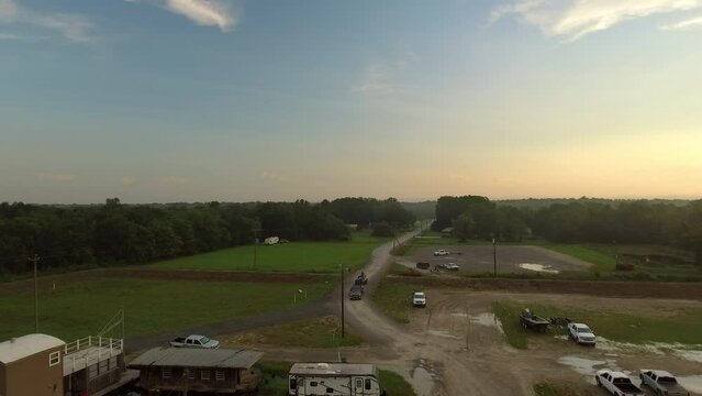 Aerial Forward Shot Of Pickup Truck Moving On Tranquil Road With Green Trees Under Sky - Bayou, Louisiana