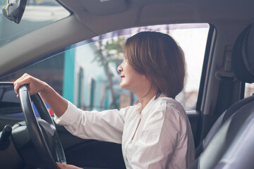 women sitting in the  seat and driving a car to go work,concentration on  driving for safety transport concept