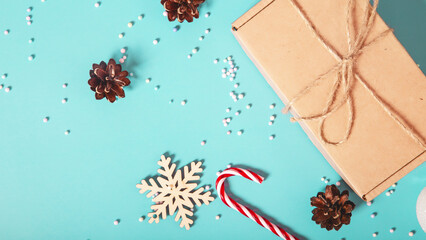 Christmas background. Candy cane and christmas decoration on a light blue background. Flat lay, top...