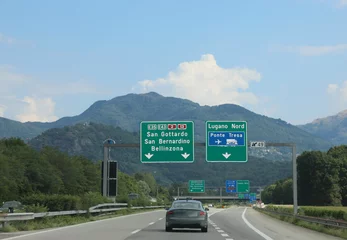 Foto op Aluminium road signs on the motorway with directions to many locations in Switzerland near the Italian border © ChiccoDodiFC