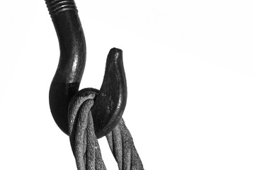 Steel hook and metal cable on white background. Device for adjusting the tension or length of cable.