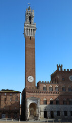 Fototapeta premium Siena Italy Tower called TORRE DEL MANGIA and the Cappella a marble tabernacle at the foot of the tower
