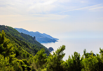 Fototapeta na wymiar Coast and lonely rocks in the sea near Sinarades on the island of Corfu