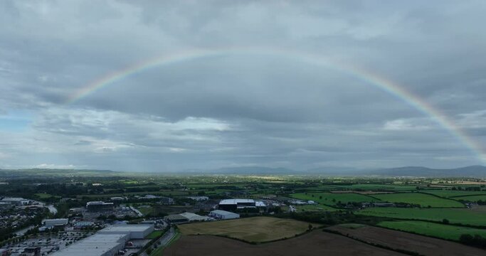 aerial view of rainbow on a green filds, flying in a rainbow in the rain 4k