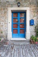 Fototapeta na wymiar Image of a blue entrance door to a residential building with an antique façade