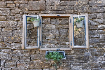 Picture of a fake window as decoration on a natural stone wall
