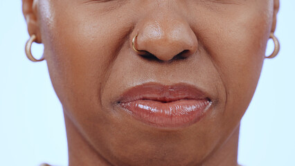 Woman, face and closeup of nose and mouth in studio with disgust for bad smell, dislike scent or...