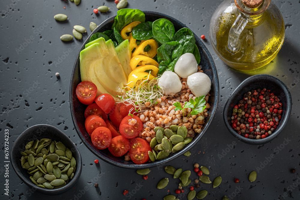 Wall mural Delicious salad with olive oil, vegetables and buckwheat groats.