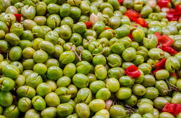 Green olives and red pepper at a market stall
