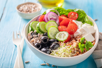 Delicious Greek salad with groats, vegetables and feta cheese.