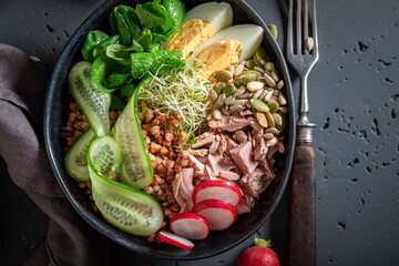 Fresh Nicoise salad with groats as fit food.