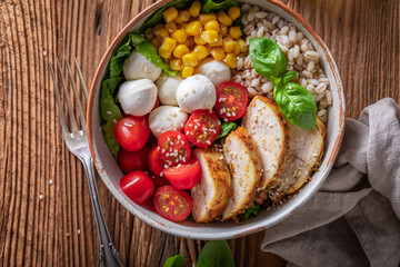 Diet Caesar salad with chicken, cheese and groats.