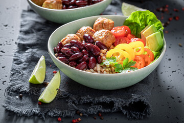 Energetic Mexican salad with groats, meatballs, vegetables and limes.