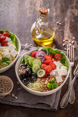 Healthy Greek salad with cheese, cucumber, olives and tomatoes.