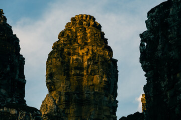 As the sun sets.  Bayon temple, Siem Reap, Cambodia in the late evening light.