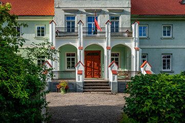 View of the facade of Pope manor and the main entrance. School works in the Manor House in our days. Latvia, Baltic.