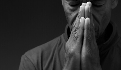 praying to God with the bible on black background with people stock image stock photo