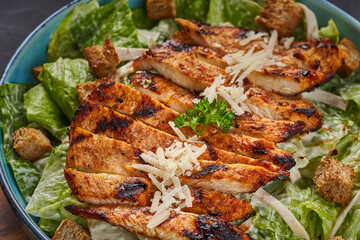 Close-up of chicken strips in a plate with vegetables and cheese
