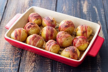 Baked potatoes with bacon and thyme. Homemade food.