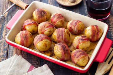 Baked potatoes with bacon and thyme. Homemade food.