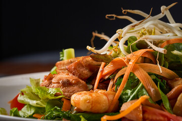 Close up photo of Seafood salad with shrimp, salmon, and fresh vegetables