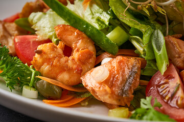Close up photo of Seafood salad with shrimp, salmon, and fresh vegetables