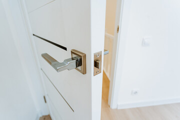 Door handle with built-in lock, latch on the jamb, modern belief in the interior of the house, door...