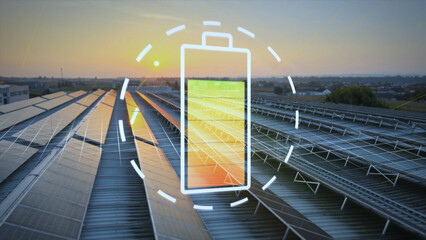 Large field of solar panels collects energy from the setting sun and charges digital battery...