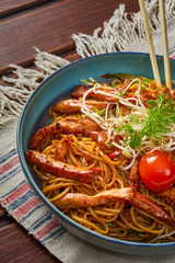 Close-up of a bowl of noodles with chicken with herbs