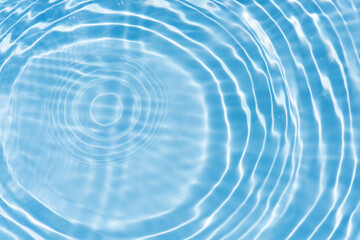 Defocus blurred transparent blue colored clear calm water surface texture with splashes reflection. Trendy abstract nature background. Water waves in sunlight with copy space. Blue watercolor shine.