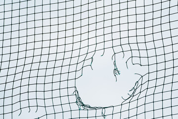 Soccer Ball Triumph. Breaking the Goal Net. Concept of football goal. Close Up of a Soccer Goal...