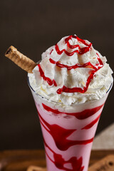 A cup of milkshakes with different flavors on a wooden floor