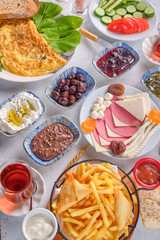 Various traditional Turkish breakfast dishes on a gray floor