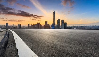 panoramic skyline and modern commercial buildings with empty road asphalt road and cityscape at sunrise