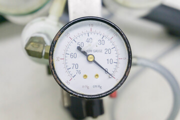 Pressure gauge on a gas regulator in a laboratory analytical equipment.