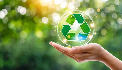 Fotobehang hand holding reduce reuse recycle symbol on green bokeh background ecological and save the earth concept an ecological metaphor for ecological waste management and a sustainable © Florence