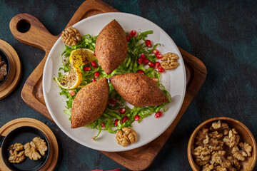 A plate of oriental fried kibbeh on a wooden floor