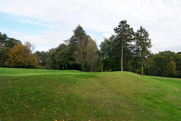 Fototapeta na wymiar golf course landscape. putting green surrounded by trees on 18 hole golf course. sport and leisure 