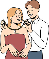 Loving man puts precious necklace around girlfriend neck to help get ready for party