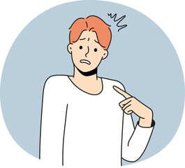 Young man point at self feeling confused